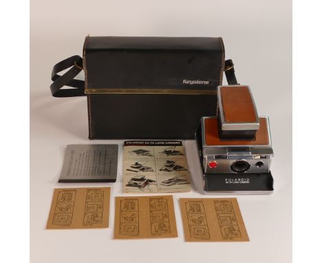 Polaroid SX-70 Land Camera. Chrome and tan covering. Includes original inserts. In Keystone leather case.
