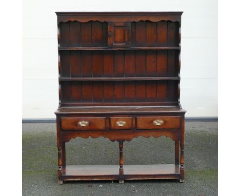 Georgian Oak Dresser. Upper section with shaped frieze and one central locking cupboard to upper shelf with key. Base has thr