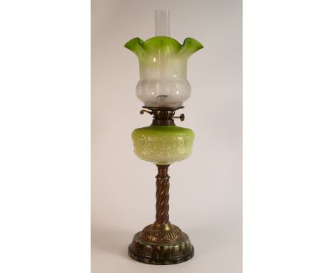Late 19th century Oil lamp. Base is of mottled earthenware with brass twist shaft below a lime milk glass reservoir with moul