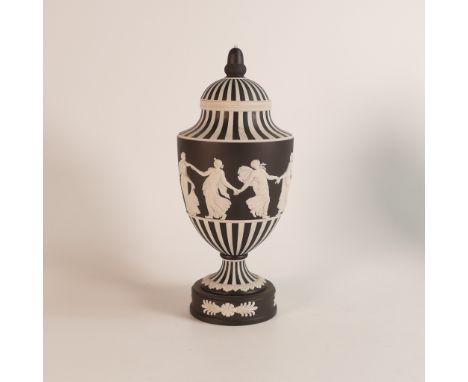 Wedgwood, dip black Jasperware 'Dancing Hours' vase and cover. Acorn finial lid on a sweeping shoulder striped in black and w