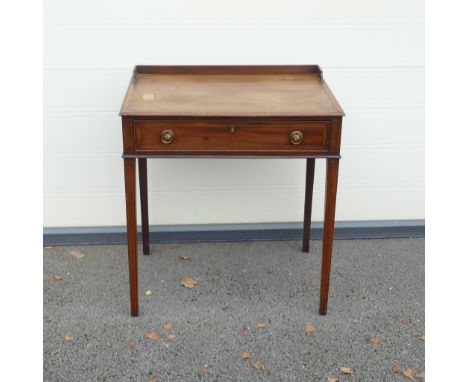 Victorian Writing table with central locking drawer. Rectangular top, low gallery to back with stepped sloped edges on four s