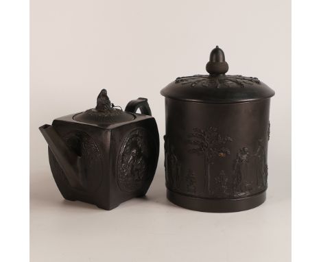 Wedgwood, Basalt biscuit barrel and cover. The body has a sacrifice scene in relief with singular relief band below. Lid has 