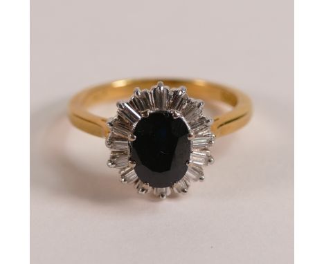 18ct gold sapphire and diamond ring, the centre oval sapphire surrounded by 16 baguette diamonds, size N, 5.1g.