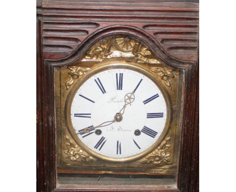 A French provincial carved walnut long case clock,&nbsp;having brass and enamel dial supporting an eight day movement