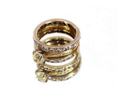 An 18 carat gold ring,&nbsp;set approx. ¾ carat diamond with diamond set shoulders, flanked by two 18 carat white gold and di