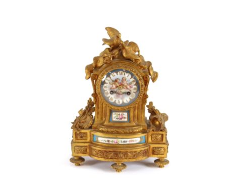 A 19th Century French gilt metal mantel clock, decorated with Sevres style porcelain panels, surmounted by doves and ornament