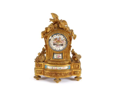 A 19th Century French gilt metal mantel clock, decorated with Sevres style porcelain panels, surmounted by doves and ornament