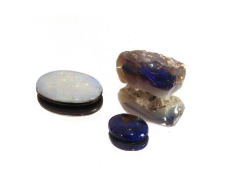 A blue uncut opal and two cut opals