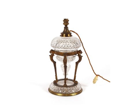 A decorative hob-nail cut glass and gilt mounted table lamp, (converted to electricity), the font supported by four monopedia