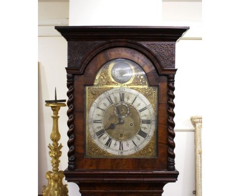 An 18th Century walnut and marquetry long case clock, by Andrew Dunlop of London, the arched fret carved hood flanked by spir