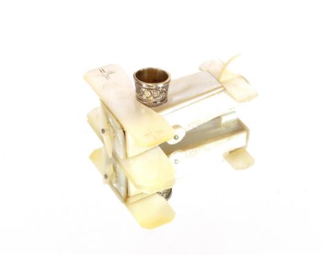 An unusual mother of pearl German marked miniature World War I model bi-plane, formed as a thimble holder, complete with silv