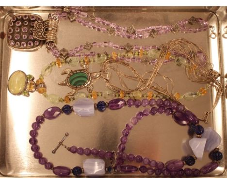 A semi precious stone and white metal necklace; an amethyst necklace; a large amethyst necklace; and an American Navajo India