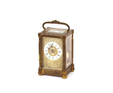 A brass cased striking carriage clock,&nbsp;with white enamel Roman numeral chapter ring and foliate engraved dial, swing han