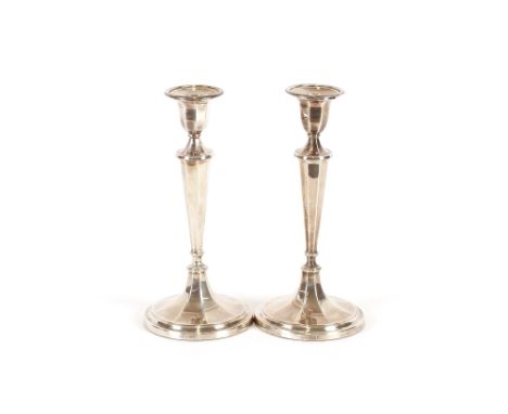 A pair of modern silver candlesticks,&nbsp;having detachable sconces raised on tapering column and octagonal spread feet, 25c