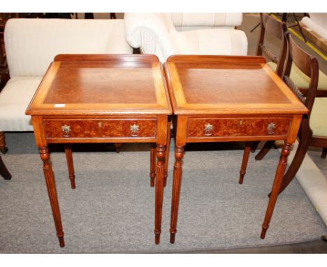 A pair of walnut and satinwood cross-banded lamp tables, fitted single drawers and raised on turned fluted supports, 54cm wid