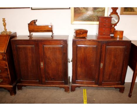 A pair of George III mahogany side cabinets, each fitted with seven oak lined dispatch box drawers, having brass escutcheons 
