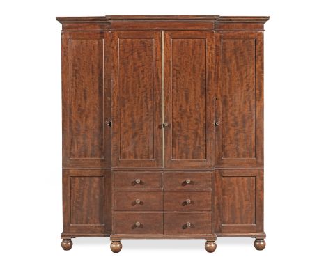 A George IV mahogany breakfront wardrobe attributed to GillowsCirca 1825, the ovolo moulded cornice above a central pair of d