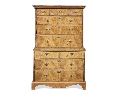 A George I walnut and featherbanded chest on chestCirca 1725, the reverse ogee moulded cornice above three short drawers, ove