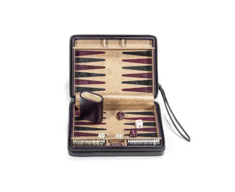 A late 20th century leather travelling backgammon set retailed by Asprey, Londonthe claret leather rectangular zipped case op