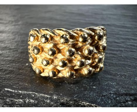 A 9ct gold hallmarked dress ring set with 4 rows of spherical nodules, size Q-R, 5.25gms.