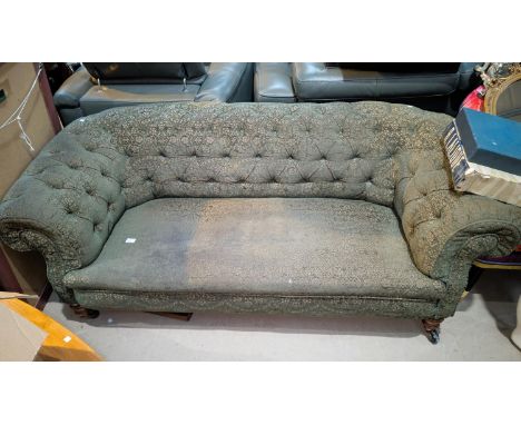 An Art Deco Chesterfield settee with patterned material cover and button back.