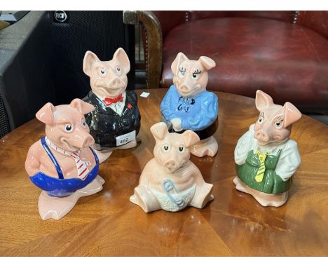 A group of five Nat West ceramic piggy banks.
