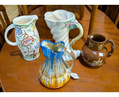 A 1930's Clarice Cliff cornucopia vase with relief floral decoration, height 25cm and other 1930's vases.