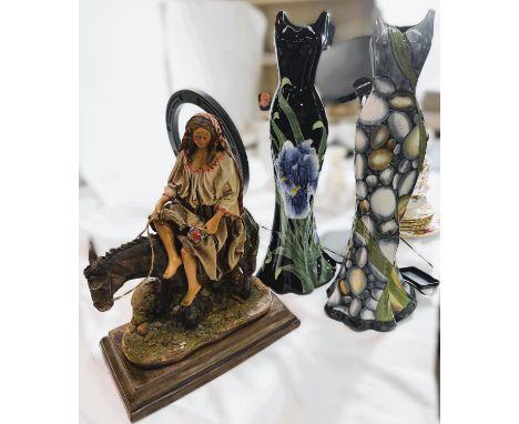 Two vases in the form of ceramic dresses, two pheasants and a woman on a donkey.