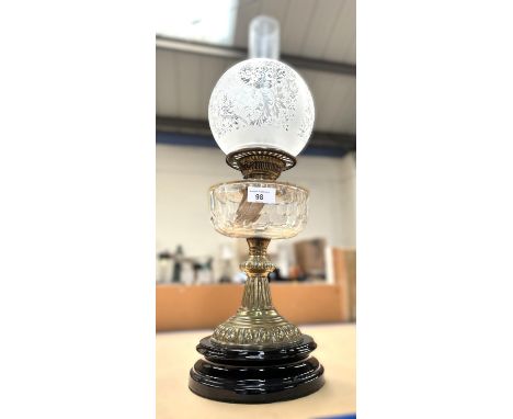 A Victorian brass column oil lamp with glass reservoir and etched shade.