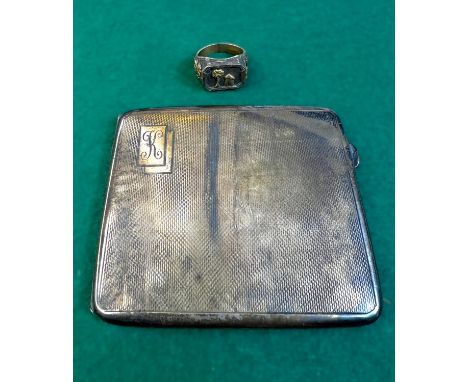 A hallmarked silver engine turned monogrammed cigarette case, 109gms and a white metal ring.