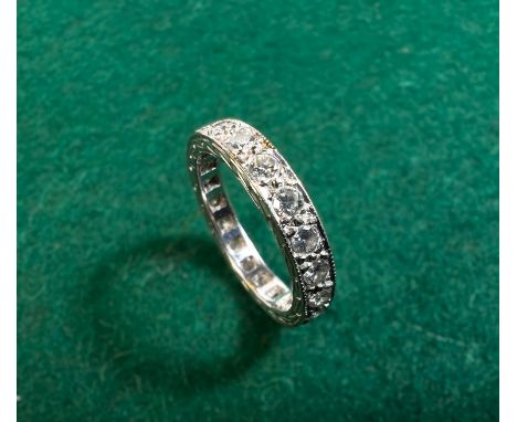 A white metal diamond set eternity ring, size 'K', 3.7gms