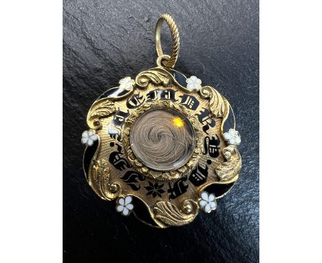 A Victorian yellow metal and black and white enamel mourning brooch with lock of hair, inscribed to rear.