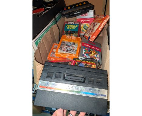An Atari console and a selection of vintage Atari games etc. and a collection of Sinclair tape games etc.