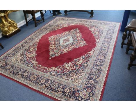 A Persian claret ground carpet, 290 x 225cm