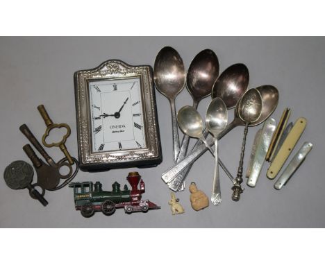 A silver mounted clock, spoons, penknives etc