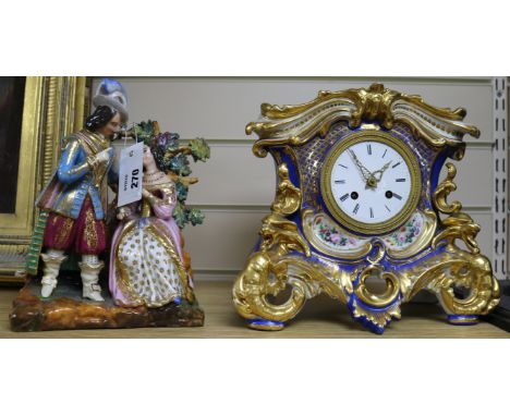 A French porcelain eight day mantel clock, with figural surmount