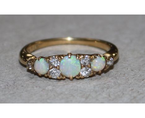 A gold, white opal and diamond dress ring, size L.