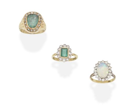 THREE GEM-SET AND DIAMOND RINGS1st: The step-cut emerald within a brilliant-cut diamond surround, 2nd: The fancy-cut emerald 