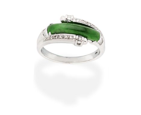 JADE AND DIAMOND RINGThe jadeite jade plaque, within closed back settings, accented by baguette and brilliant cut diamonds,  