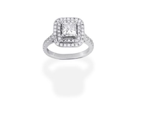 DIAMOND CLUSTER RINGSet with a princess-cut diamond, within a brilliant-cut diamond surround, principal diamond approx. 0.90c