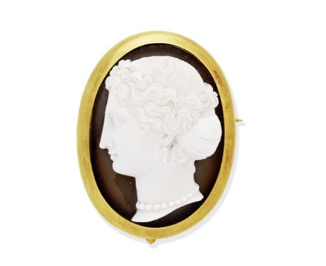 HARDSTONE CAMEO BROOCH/PENDANT, 1860Carved to depict a female portrait in profile, wearing an archaeological revival earring,