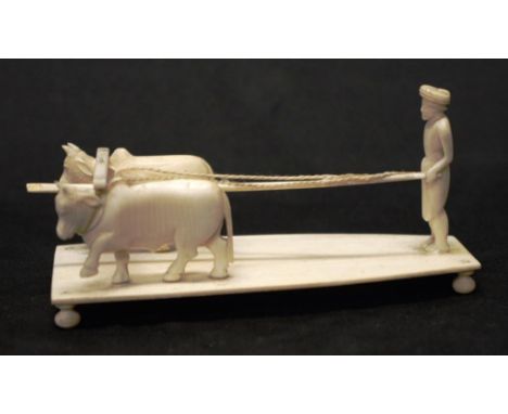 Oriental carved ivory Figure with Buffalos depicting Farmer with pair Buffalo ploughing a field, (length 13cm approx). NOTE: 