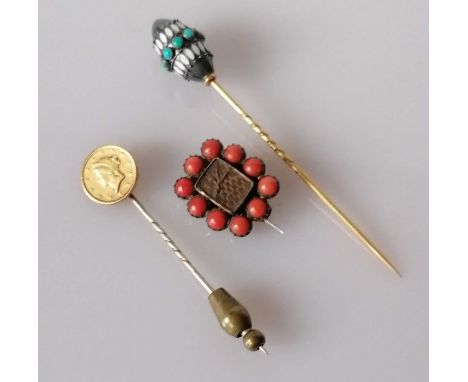 A 19th century One Dollar Liberty coin stick pin, date obscured, 14mm diameter; a Victorian mourning brooch with coral decora