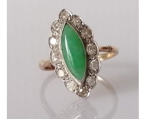 An Art Deco marquise-cut jade cocktail ring surrounded by twelve round-cut diamonds, each measuring approximately from 0.05 t