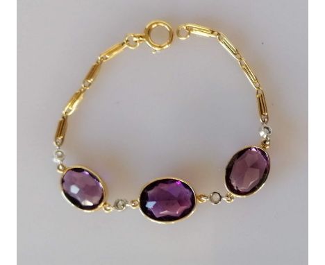 An 18ct yellow gold amethyst and diamond bracelet, 16.5 cm, with three mixed oval-cut amethysts in original Hamilton &amp; In