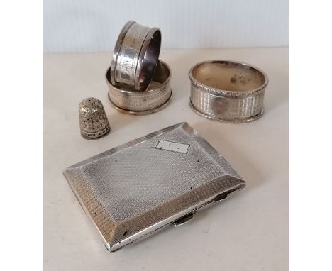 A George V silver cigarette case with engine turned design by JR, Birmingham, 1926, 8 x 6.5 cm; a pair of napkin rings, one o