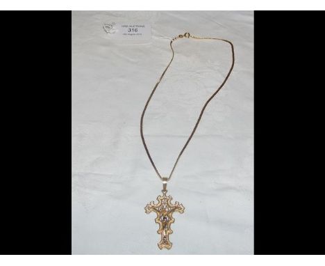 An elegant 750 marked gold crucifix and chain (16g) 