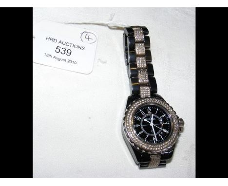 A Chanel J12 black ceramic and diamond bezel lady's wrist watch - the strap set with inset diamond bracelet CONDITION REPORTw