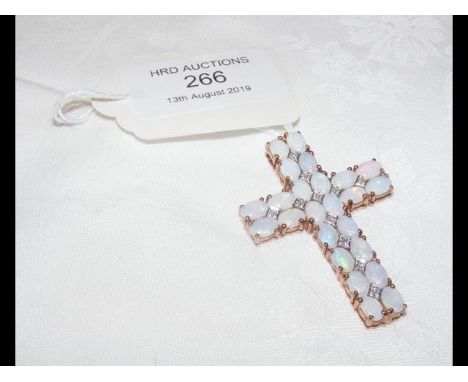 An opal and diamond cross pendant in 9ct gold mount CONDITION REPORTno bale on the cross as per images