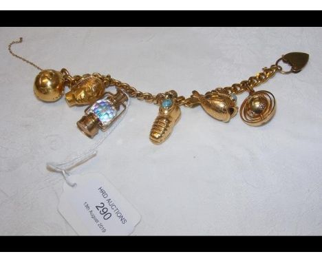 A lady's 9ct gold charm bracelet, having five 18ct gold charms and one 9ct gold charm - 75g 